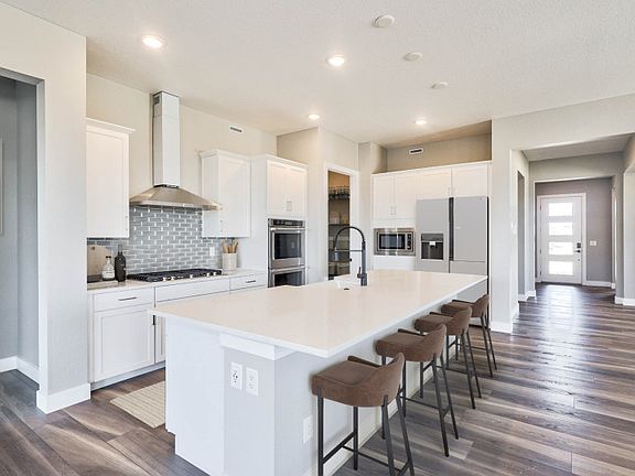 Enter the Preserve kitchen to find a large island, ample cabinet space, and built-in appliances.