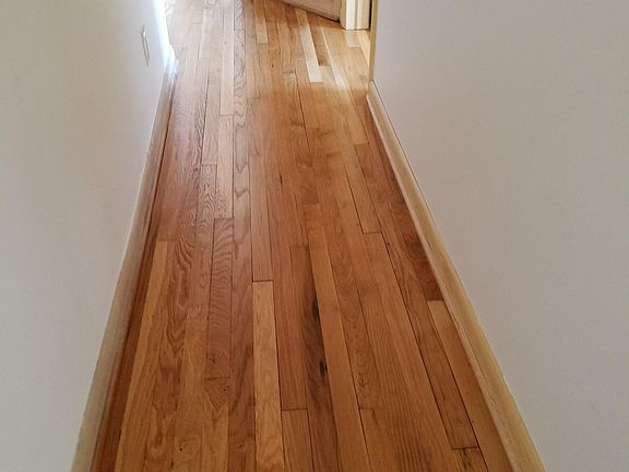 hallway coming from kitchen area leading to bedrooms and bath room.