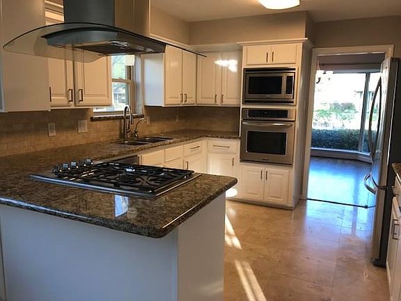 Updated kitchen with travertine tile.