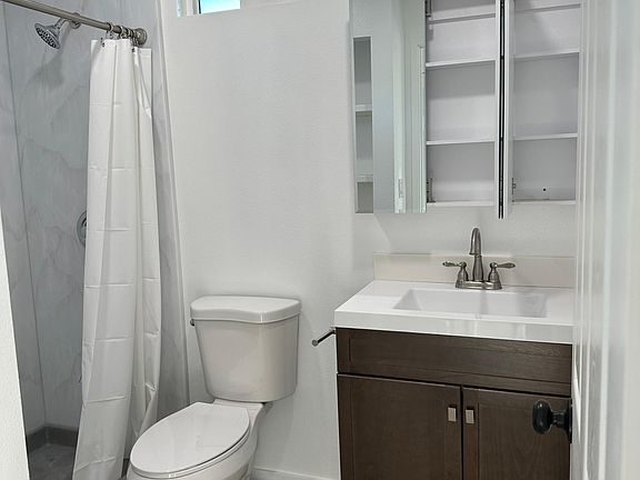 Brand new bathroom with new vanity, toilet and solid surface shower walls installed