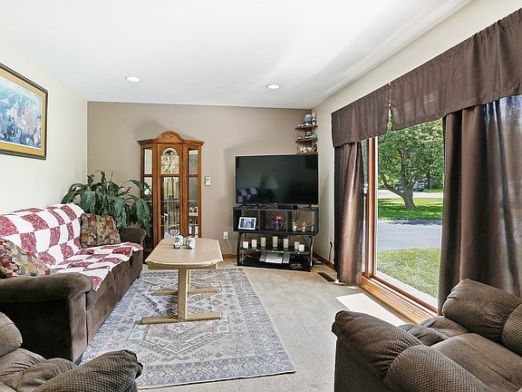 Full height windows let the southern sun stream into this lovely living room.    Brand new, cushy ca