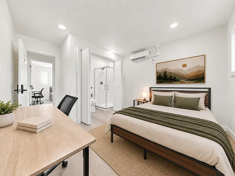 Private bedroom with desk workspace, window, and mini-split A/C, plus convenient access to an en-suite bath.