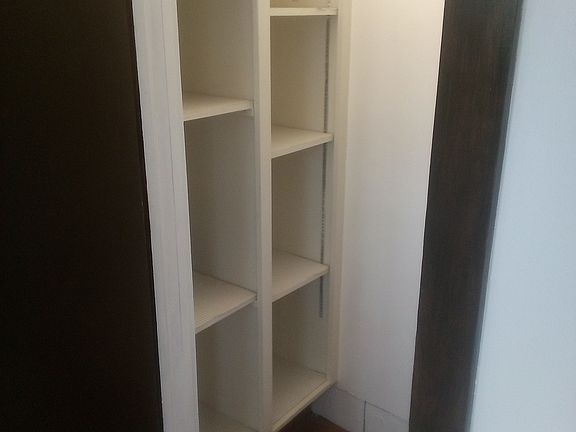 Pantry storage next to kitchen. Leads to basement.