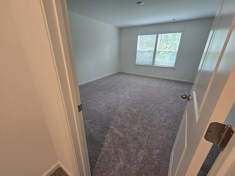 Master bed with big window (on back of the house)