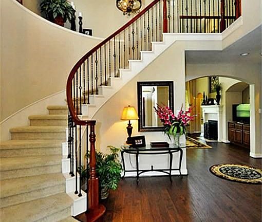  SOARING TWO STORY ENTRY WITH GORGEOUS HARDWOOD FLOORING AND WROUGH IRON LIGHTING