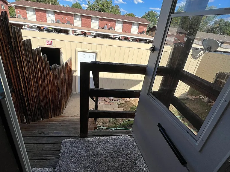 back door access to small backyard and 2-car garage