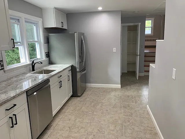 Large Kitchen (tile floor) with view of the raised bedroom and 1 of 2 hall closets