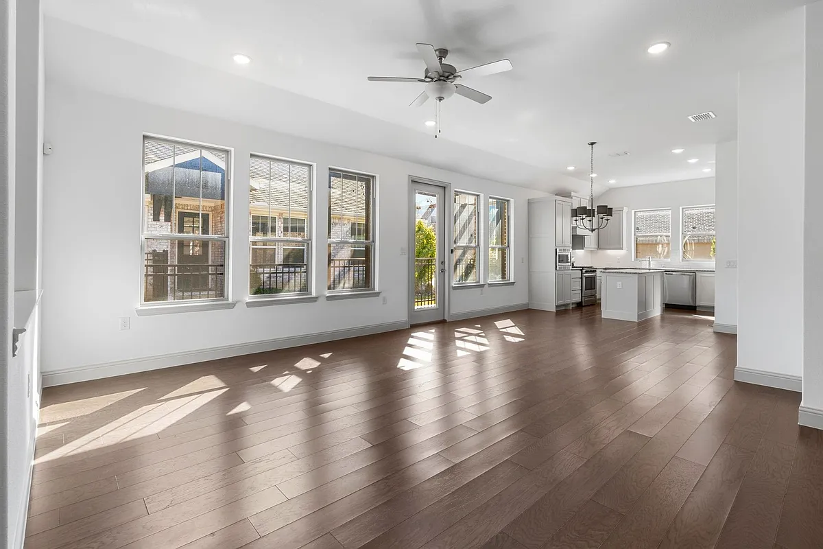 Open-concept living space featuring wood-finish flooring, recessed lighting, and a modern ceiling fan - 4559 Stone Valley Trl