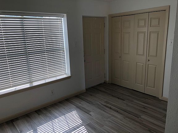 Large window at dining area, and door set for laundry area.