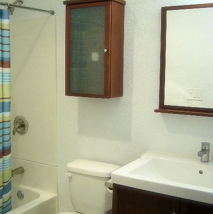Bright and modern bathroom with easy clean all-in-one shower/tub!
