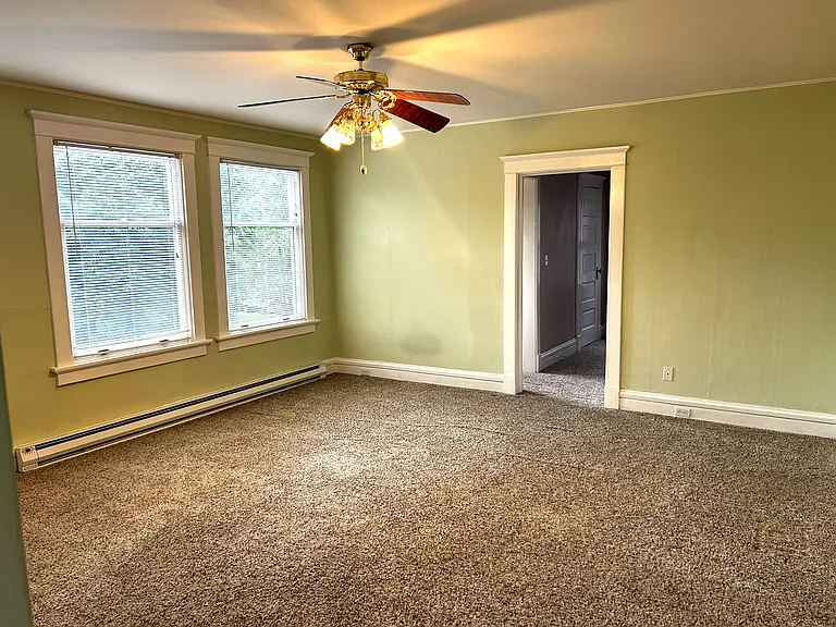 Another angle of living room that leads to large bedroom with 2 walk-in closets.