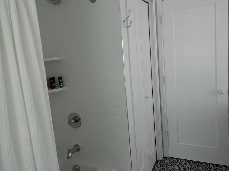 Second bathroom has tiled shower/ tub combination with quartz shelves. Large linen closet with deep shelves