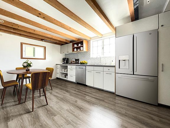 The wall in this photo has been removed, making for a seamless transition from kitchen to living space.