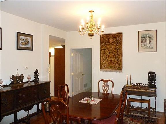 Large open dining room with hardwood flooring.