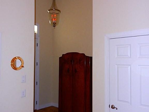 Entry has porcelain tile and storage under the stairs