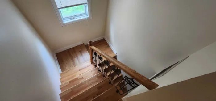 Back Stairwell from private rear/side entrance with a louvered window.