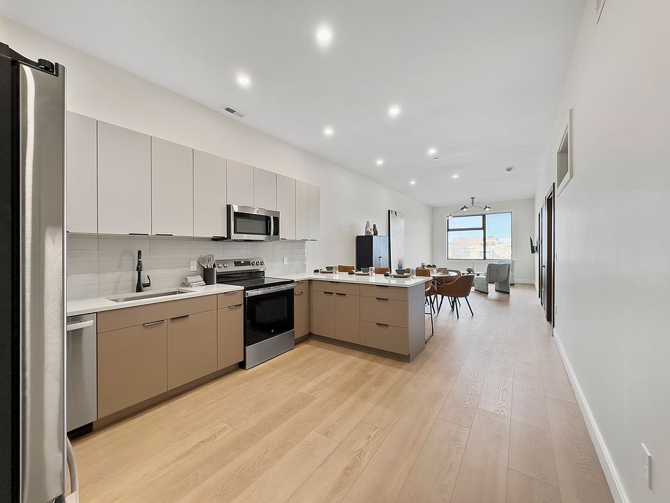 Open concept kitchen, dining and living room area.