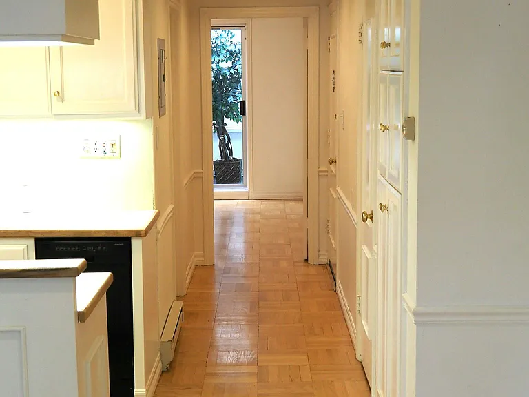 Hallway to bedroom, kitchen to left