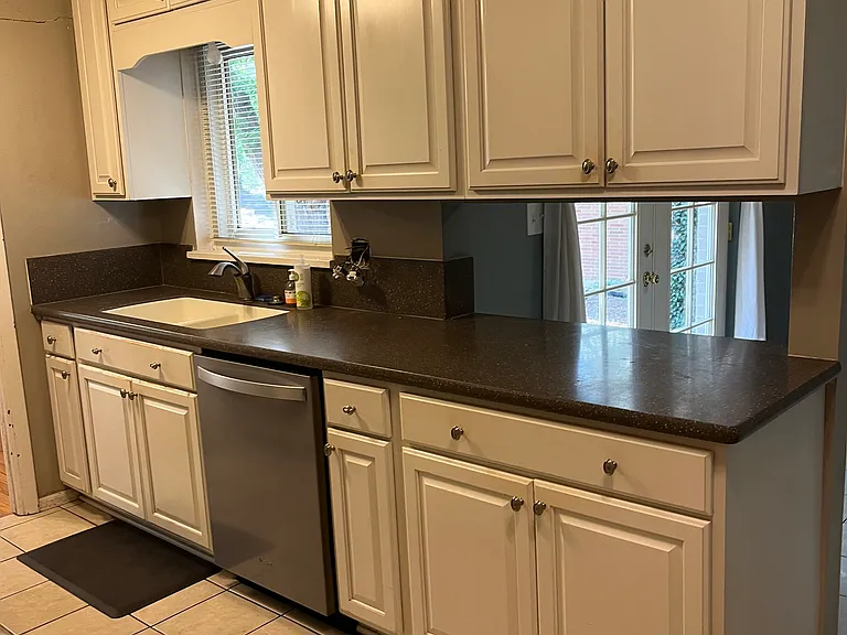 Nice kitchen with white cabinets and stainless steel appliances.