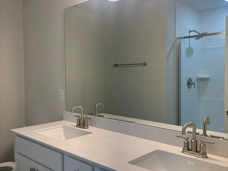His/hers sink plus spacious shower with seating and glass doors.