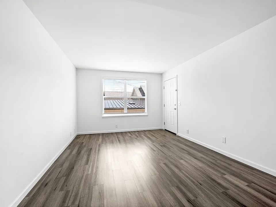 Living room with large laundry room.