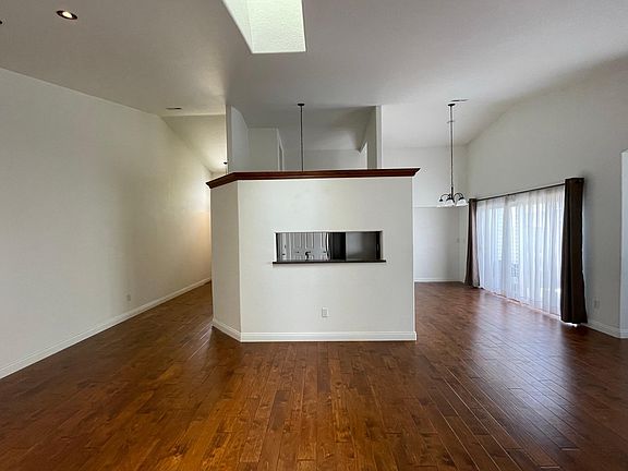 Kitchen in the middle with window openings to the living and dining room