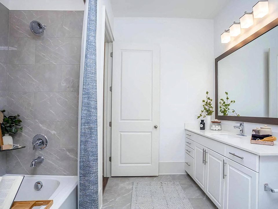Bathroom Featuring Tile Shower Wall and Extended Countertop with Sink
