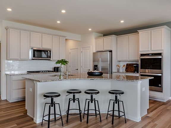 Kitchen with Featuring a Curved Island