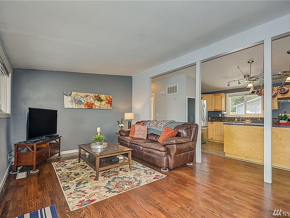 Cozy living room off of the entry way, great for entertaining, open to the kitchen!