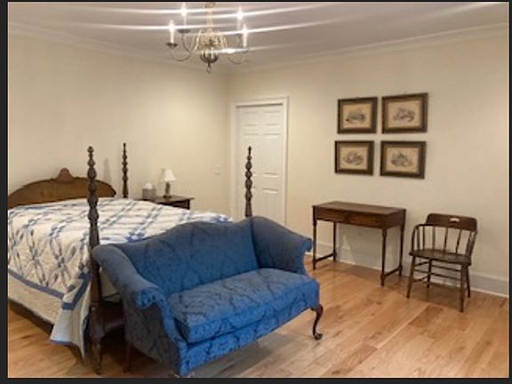 Bedrooms include night stand, desk, chair, sitting area with wingback chair & loveseat, & large windows with private views.
