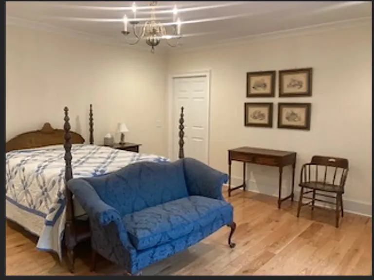 Bedrooms include night stand, desk, chair, sitting area with wingback chair & loveseat, & large windows with private views.