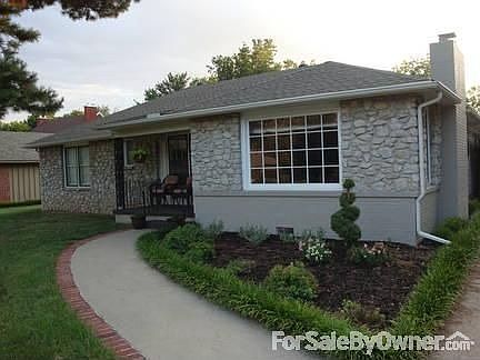 Front Entry
						:
						Fresh landscape greets you as you walk up the curved path trimmed in red brick.