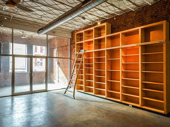 Built-in shelving with library ladder.
