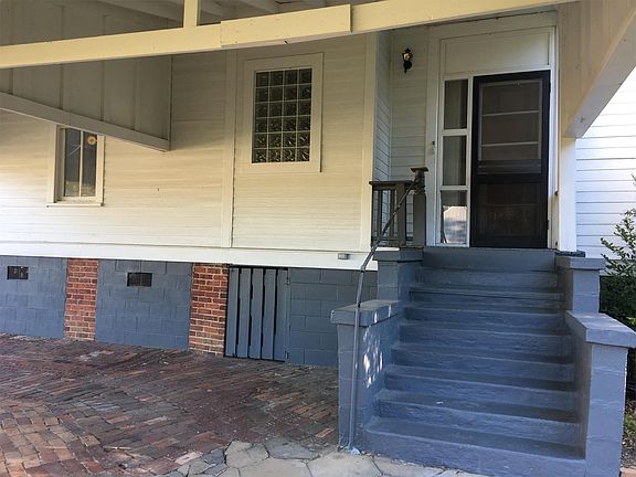 View of back steps and door from carport