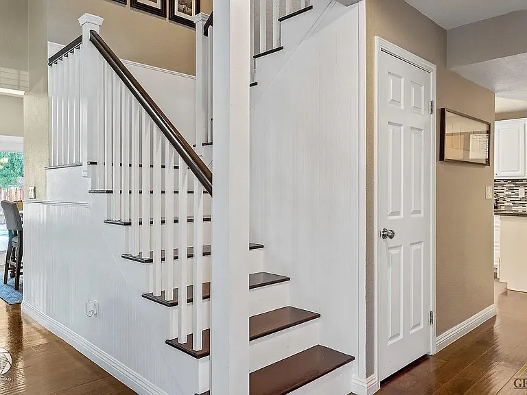 Stairs and pathway to kitchen and back living room area