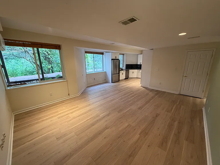Open concept living room 7 kitchen area with tons of natural light