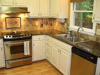 Updated kitchen with stone tile backsplash, Silestone, countertops, ss apps