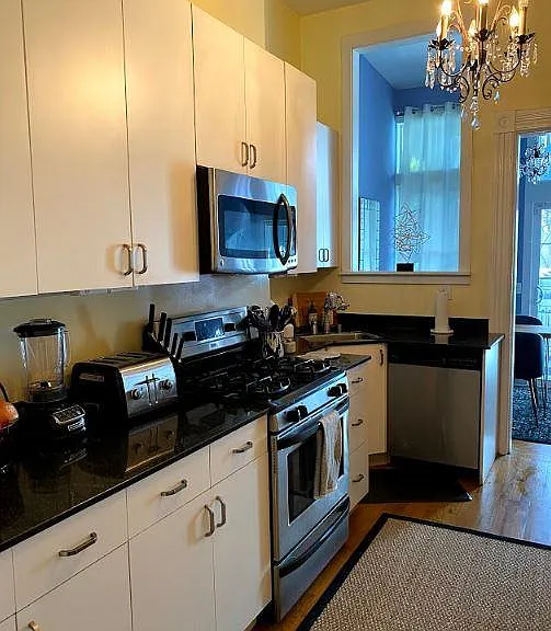 Spacious kitchen with plentiful marble counter-top and cabinetry. Built in microwave and vent above stove/oven, Dishwasher next to sink. Lots of natural light.