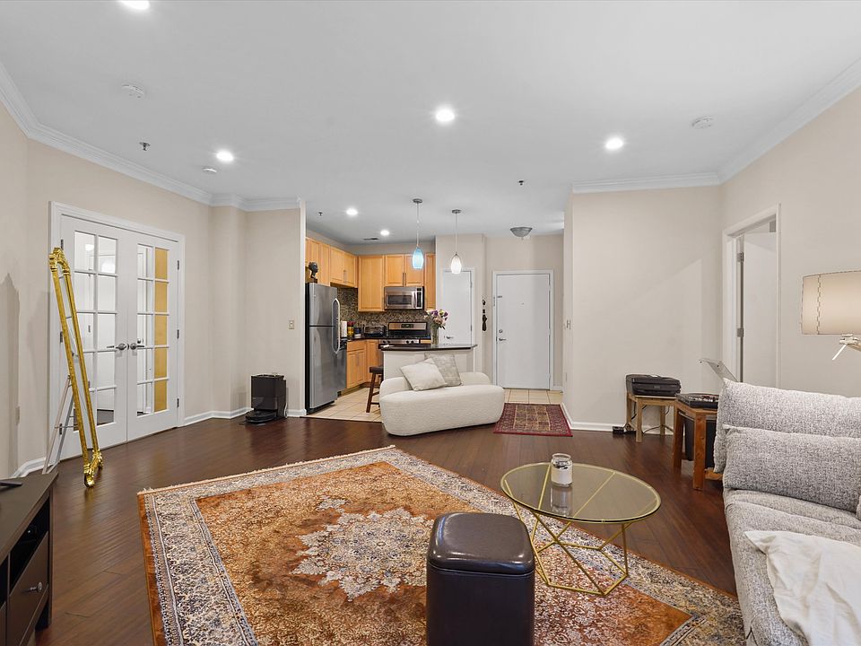 Living room: Inviting flow from kitchen to living space, with warm hardwood floors and natural light throughout.