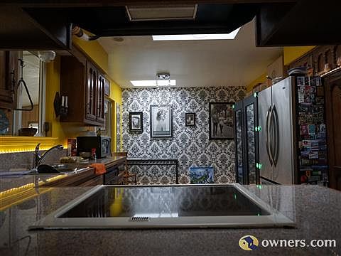 View of kitchen/dining area with 3 skylights