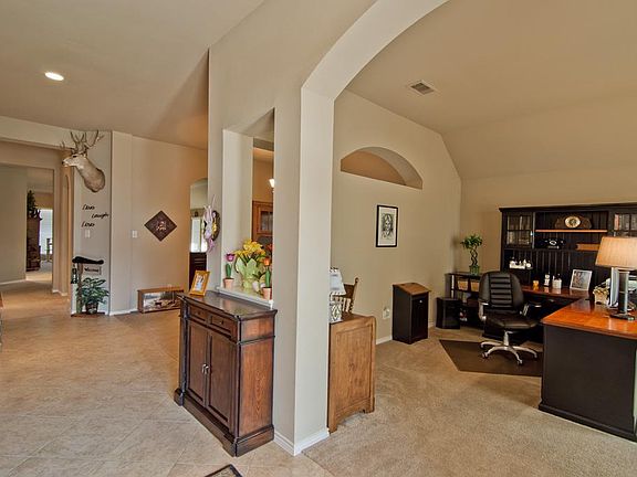 Upon entry, the formal living room is immediately to the right. High ceilings, recessed lighting, an
