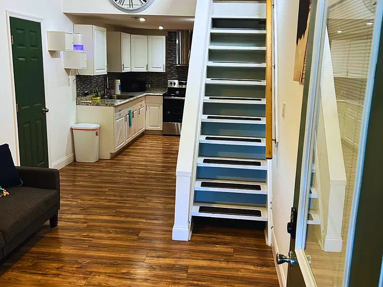 Bright open layout with a fully equipped kitchen and cozy living space.