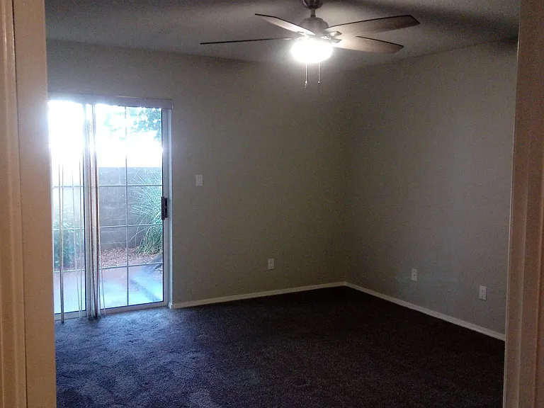 Large master bedroom with sliding door to backyard