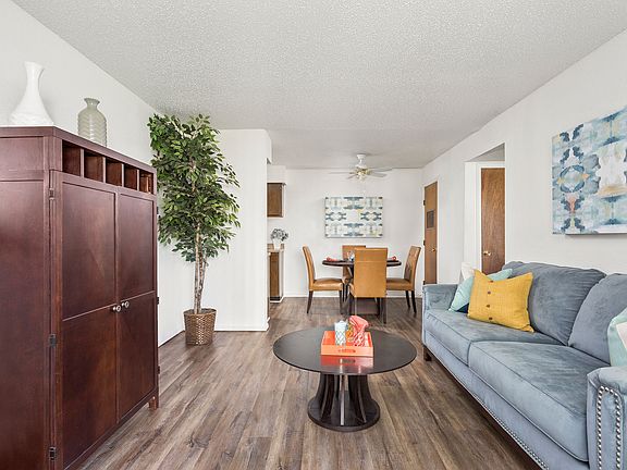 Long View of Living Room with Hardwood Floors - Raindance Apartments