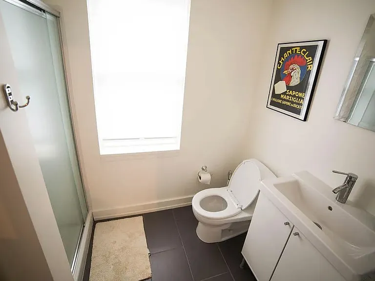 Bathroom with tiled shower stall.