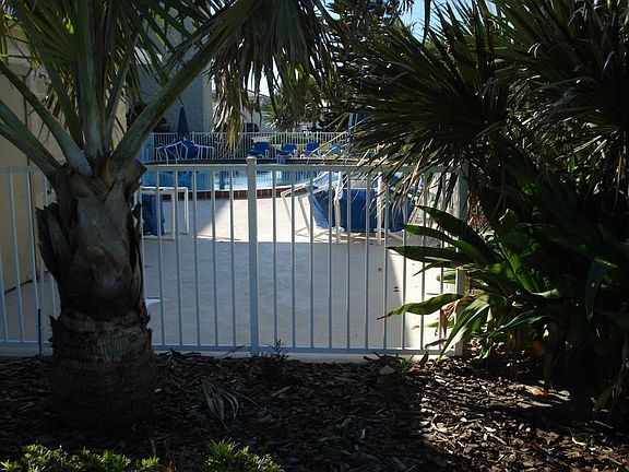 Pool deck is beautifully landscaped.