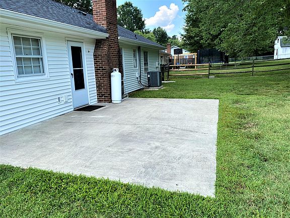 Large concrete Patio just off the dining room area perfect for cook-outs.