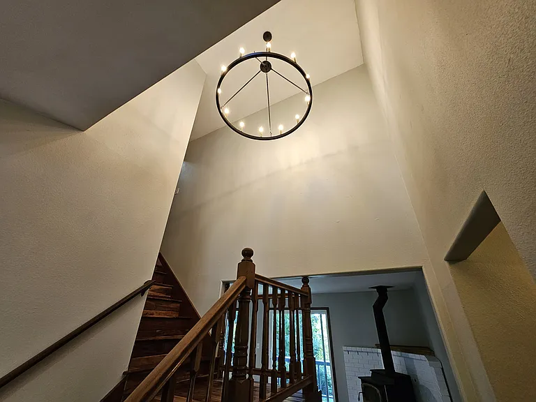 Tall ceilings in entry-way with luxurious chandelier.