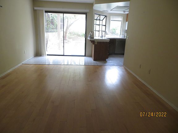 downstairs: Open concept of family room and kitchen area, leaving to backyard and patio