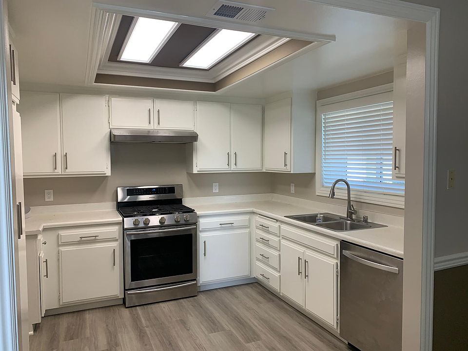 View of spacious kitchen, with ample cabinetry and new appliances.